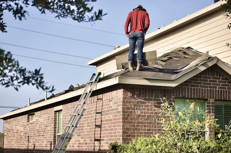 Professional roofer working on a residential roof in Downtown Colorado Springs
